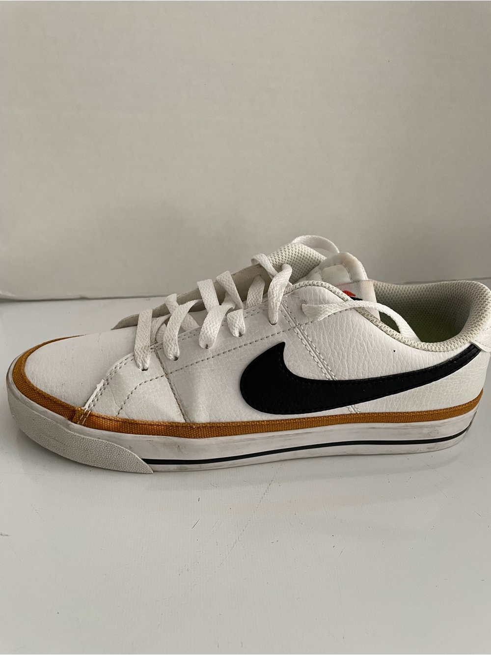 Nike White Low-Top Sneakers with Black Swoosh and Brown Trim